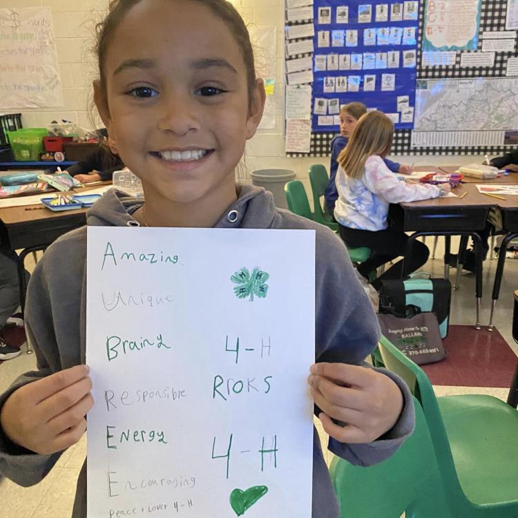  4-H club member holding poster